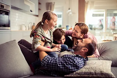 family laughing and playing in pest free home