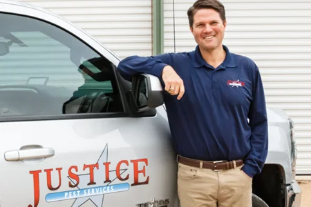 owner standing next to truck