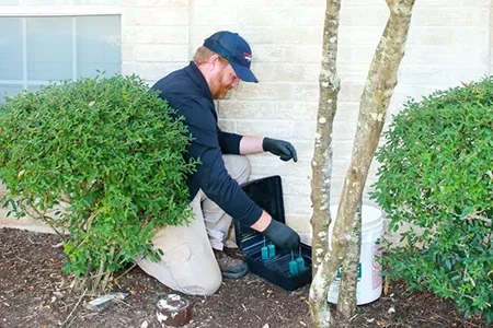 technician setting rodent bait station